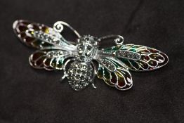 A LARGE SILVER PLIQUE A JOUR WINGED INSECT BROOCH / PENDANT, set with cabochon ruby eyes and