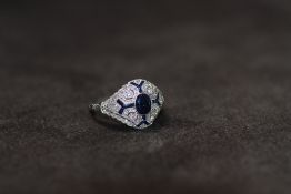 A VICTORIAN STYLE PLATINUM SAPPHIRE AND DIAMOND RING, set with a central oval-cut sapphire. The