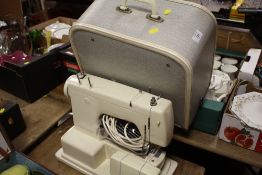 A VINTAGE CASED FRISTER & ROSSMAN ELECTRIC SEWING MACHINE