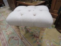 A MODERN UPHOLSTERED STOOL