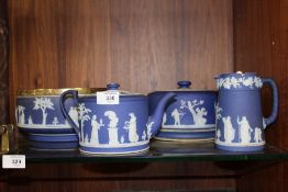 FOUR PIECES OF WEDGWOOD BLUE DIP JASPERWARE COMPRISING CHEESE DOME, TEA POT, FRUIT BOWL WITH