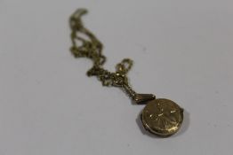 A 9CT GOLD BK & FT LOCKET ON CHAIN