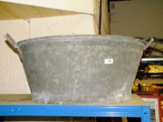 A LARGE METAL TWIN HANDLED TUB