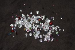 A BAG OF LOOSE MIXED STONES, including cubic zirconia, ruby, garnet, jade and sapphire 91.95ct