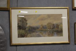 A GILT FRAMED AND GLAZED WATERCOLOUR DEPICTING A COUNTRY RIVER SCENE WITH CATTLE GRAZING
