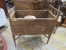 A VINTAGE WICKER COT