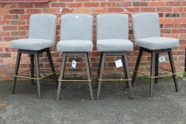 A SET OF FOUR MODERN GREY UPHOLSTERED SWIVEL BAR STOOLS