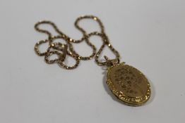 A YELLOW METAL LOCKET ON 9CT GOLD CHAIN