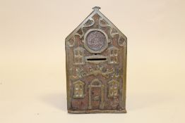 AN ANTIQUE BRASS MONEY BANK, DATED 1881