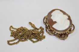 A LARGE VICTORIAN CAMEO BROOCH, TOGETHER WITH A ROLLED GOLD MUFF CHAIN (2)