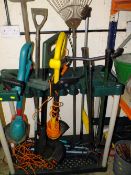 A PLASTIC GARDEN TOOL STAND PLUS GARDENING TOOLS