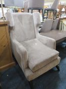 A MODERN UPHOLSTERED WINGBACK ARMCHAIR
