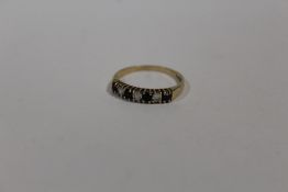 A 9 CARAT GOLD DRESS RING SET WITH SAPPHIRES AND CLEAR STONES