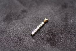 A SEVEN STONE DIAMOND PENDANT STAMPED .375