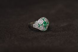 A PLATINUM VICTORIAN STYLE EMERALD AND DIAMOND DRESS RING, set with a central oval shaped emerald