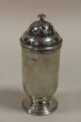 A HALLMARKED SILVER SUGAR CASTOR WITH TWIST TOP APPROX WEIGHT - 147.4G