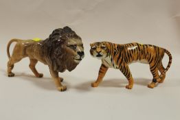 TWO BESWICK GLOSS FINISH FIGURES IN THE FORM OF A LION AND A TIGER