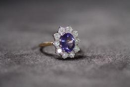 AN 18CT YELLOW GOLD TANZANITE AND DIAMOND CLUSTER RING, Oval-cut tanzanite 2.46ct. RBC diamonds 1.