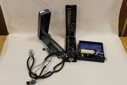 A COLLECTION OF VINTAGE MEDICAL EQUIPMENT, TO INCLUDE STETHOSCOPES, BLOOD PRESSURE KIT ETC.