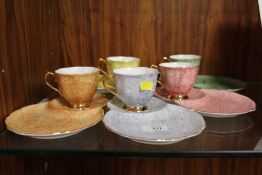 A SET OF FIVE HARLEQUIN COLOURED ROYAL ALBERT GOSSAMER CUPS AND SERVING SAUCERS