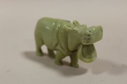 AN ORIENTAL STYLE CARVED HARD STONE HIPPO FIGURE