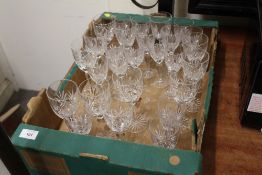 A TRAY OF CUT GLASS DRINKING GLASSES