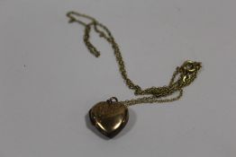 A 9CT GOLD BK & FT HEART LOCKET ON CHAIN