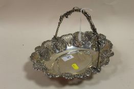 A HALLMARKED SILVER SWING HANDLED FLORALLY EMBOSSED BASKET APPROX WEIGHT - 393.3G
