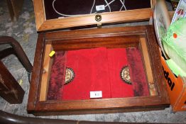 AN OAK CASED SLOPED GLAZED TABLE TOP DISPLAY CABINET