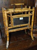 A VICTORIAN BAMBOO AND LACQUERED PAPER RACK