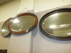 A CARVED OAK OVAL WALL MIRROR TOGETHER WITH ANOTHER OAK MIRROR AND A LARGER OVAL EXAMPLE (3)