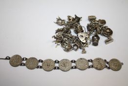 A SILVER CHARM BRACELET TOGETHER WITH A COIN BRACELET