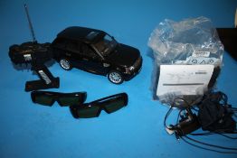 A RASTAR REMOTE CONTROL RANGE ROVER SPORT VEHICLE WITH STAND AND CHARGER TOGETHER WITH TWO PAIRS