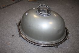 A VINTAGE SILVER PLATED FOOTED TRAY TOGETHER WITH A MATCHED PEWTER SERVING DOME (2)