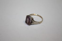 A VINTAGE 9CT GOLD AND SILVER DRESS RING SET WITH A PURPLE STONE