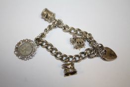 A HALLMARKED SILVER CHARM BRACELET