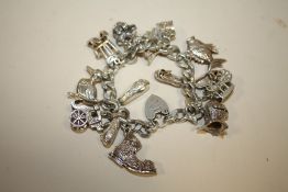 A HALLMARKED SILVER CHARM BRACELET