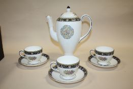 A WEDGWOOD RUNNYMEDE COFFEE POT AND THREE CUPS AND SAUCERS