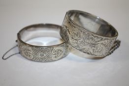 A HALLMARKED SILVER ENGRAVED BANGLE TOGETHER WITH ANOTHER