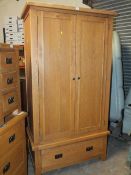 A MODERN DOUBLE OAK WARDROBE WITH DRAWER BELOW H-198 CM W-107 CM