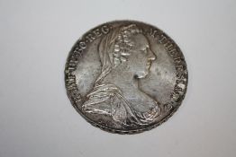 A LARGE WHITE METAL COIN