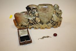 A ANTIQUE ORIENTAL STYLE SOAP STONE CARVING TOGETHER WITH A CHERRY AMBER STYLE BEAD AND A YELLOW