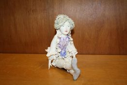 A STUDIO CERAMIC FIGURE OF A SEATED LADY