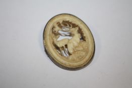 AN ANTIQUE SILVER MOUNTED CARVED BROOCH