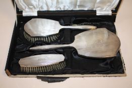 A HALLMARKED SILVER THREE PIECE BRUSH AND MIRROR SET