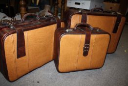 A SET OF THREE CUSTOM LEATHER SUITCASES