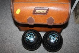 A LEATHER BAG OF THOMAS TAYLOR LAWN BOWLS