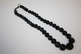 A CARVED WHITBY JET BEADED NECKLACE