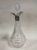 A LARGE CUT GLASS DECANTER WITH HALLMARKED SILVER COLLAR