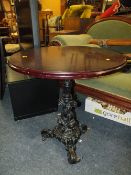 A CIRCULAR PUB TABLE WITH CAST LEGS K285